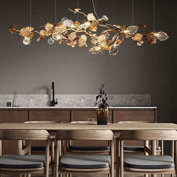 Elegant Lotus chandelier featuring delicate lotus leaf pendants made of transparent material, capturing light with a crystalline shimmer. The slender, organic brass copper branch adds warmth, while the LED lights provide a cool glow. Ideal centerpiece for a sophisticated dining area or tranquil bedroom retreat.