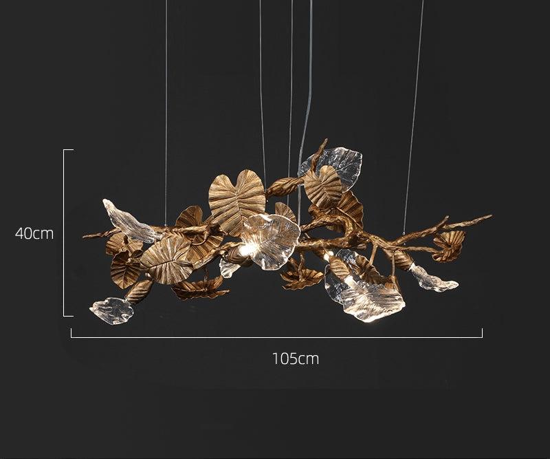 Elegant Lotus chandelier featuring delicate lotus leaf pendants made of transparent material, capturing light with a crystalline shimmer. The slender, organic brass copper branch adds warmth, while the LED lights provide a cool glow. Ideal centerpiece for a sophisticated dining area or tranquil bedroom retreat.